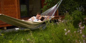 The mother,father and son lie on the hammock